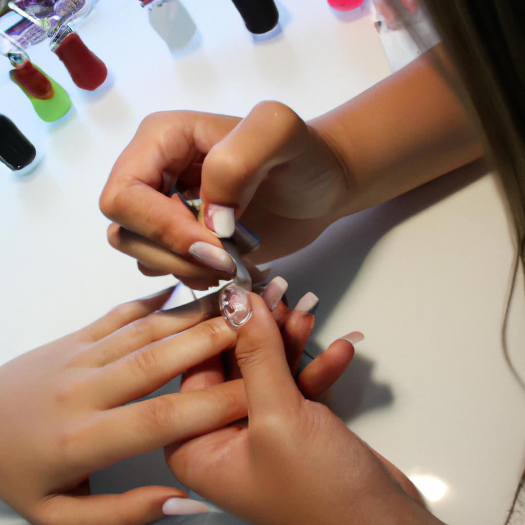 Person applying nail extensions professionally